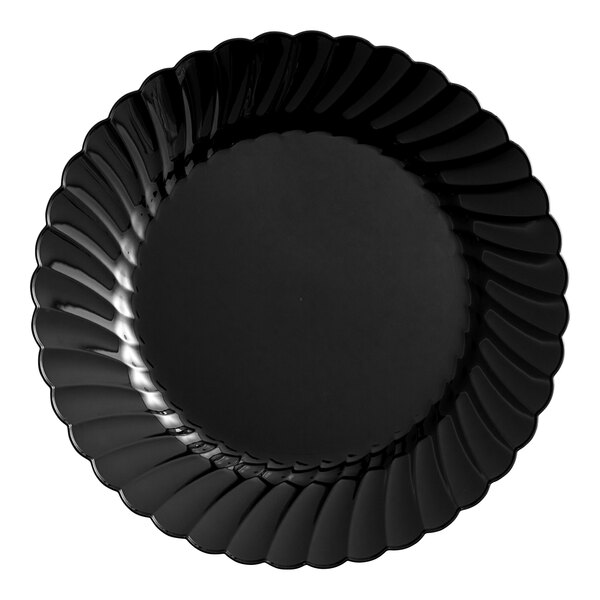 A black plastic plate with a scalloped edge.