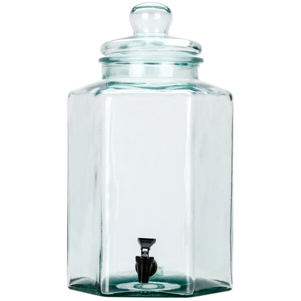 A clear glass jar with a black tap and lid.