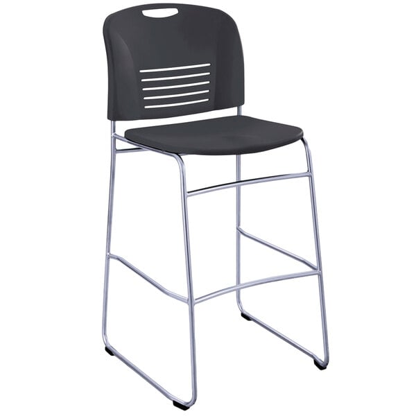 A black plastic Safco Vy Series stackable bistro chair with a metal sled base.