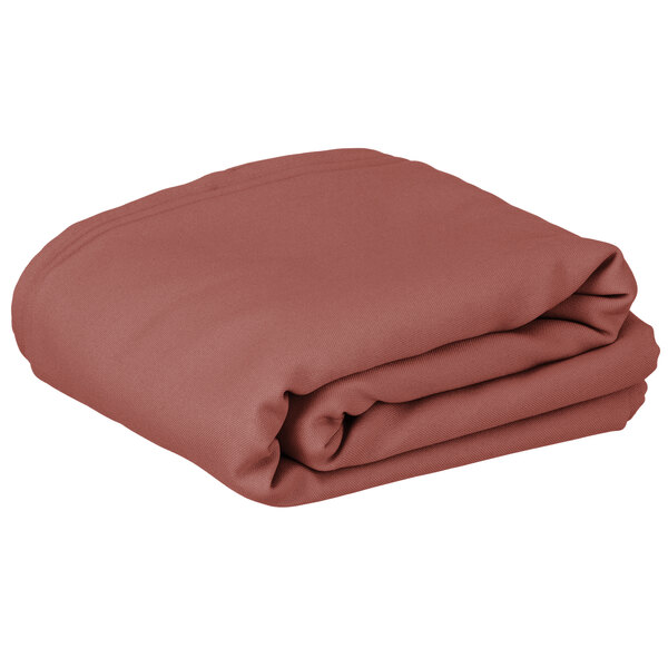A folded mauve rectangular cloth table cover.