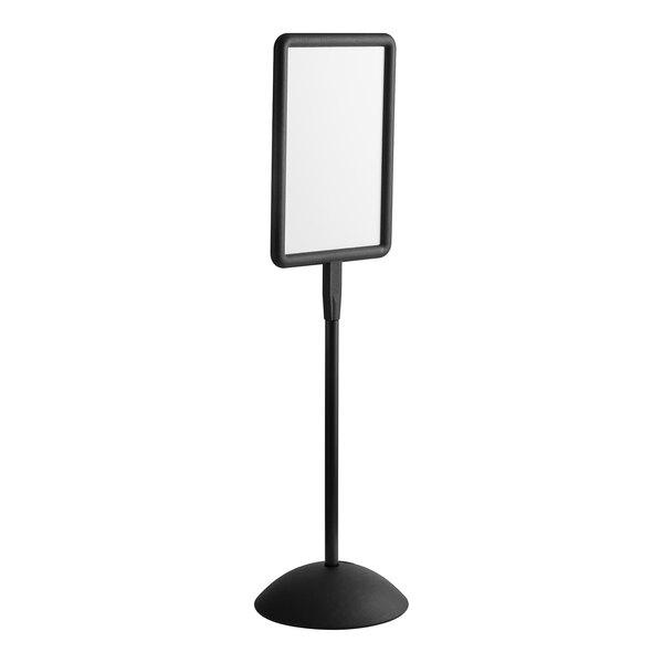 A black rectangular Safco double sided magnetic/dry erase sign with a black frame on a stand.