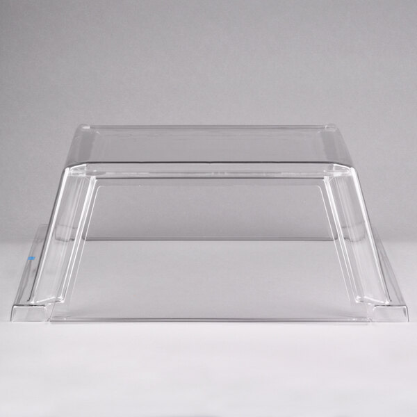 A clear plastic sneeze guard with a white border over a Star Grill Max hot dog roller grill.