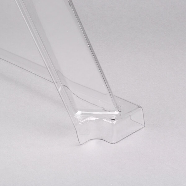 A clear plastic sneeze guard on a white surface.