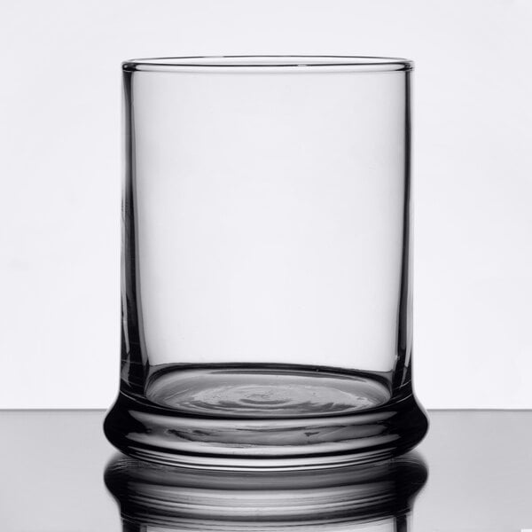 A clear Libbey glass votive holder with a small base.