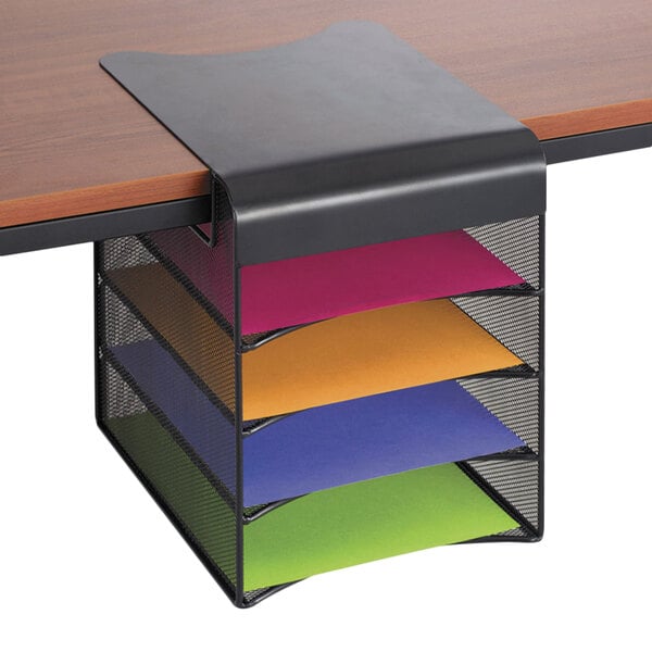 A desk with a Safco Onyx Black solid top hanging storage rack holding colorful papers.