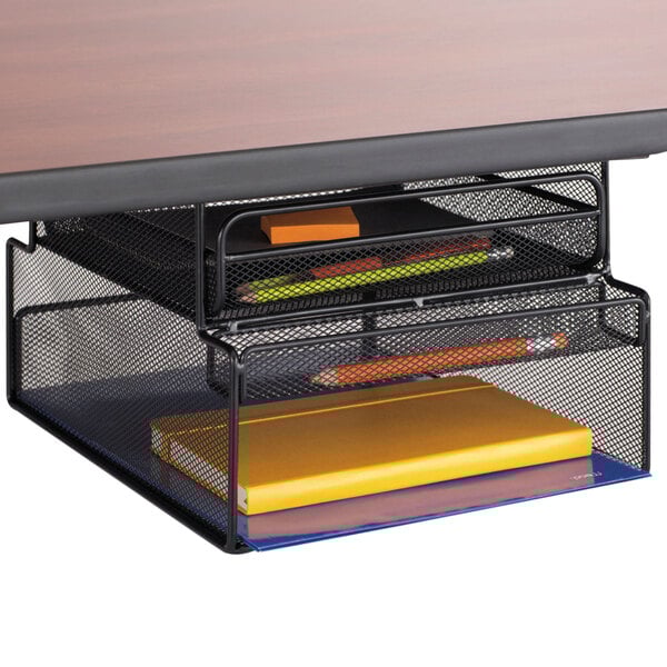 A black Safco Onyx hanging storage unit on a desk with books and a notebook.