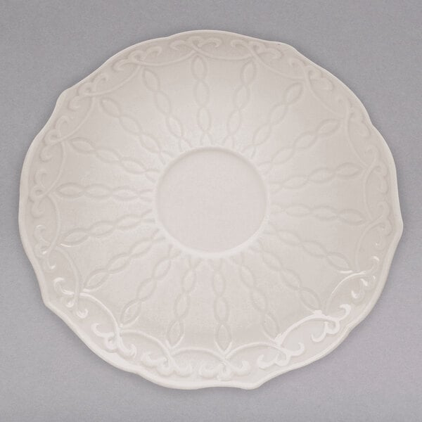 A white 10 Strawberry Street saucer with a circular design.