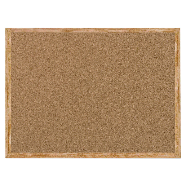 A MasterVision cork bulletin board with an oak frame.