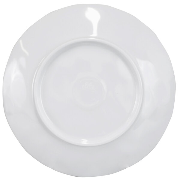 A white plate with a wavy circular edge.