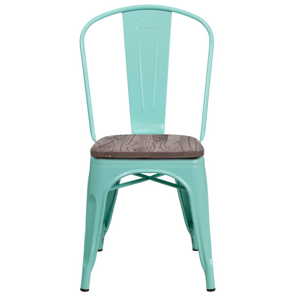 A mint green metal chair with a wood seat.