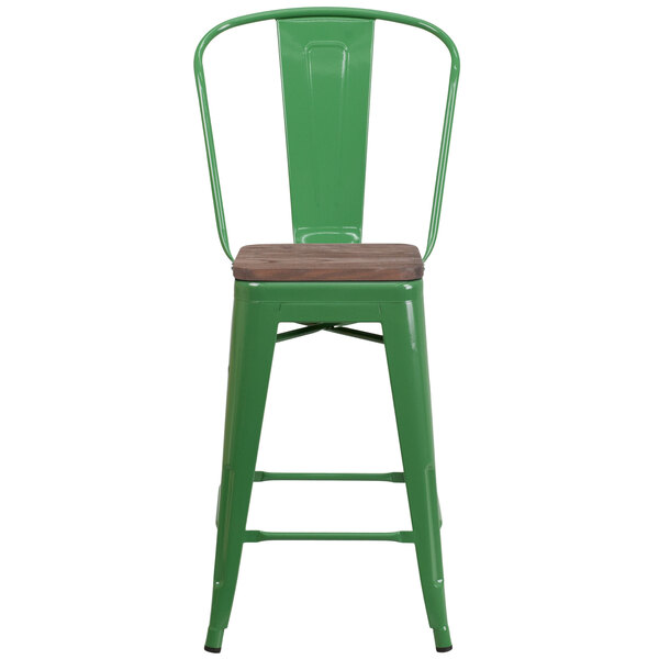 a green metal chair with a wooden base