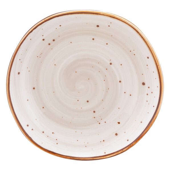 A white 10 Strawberry Street china plate with a brown speckled design.