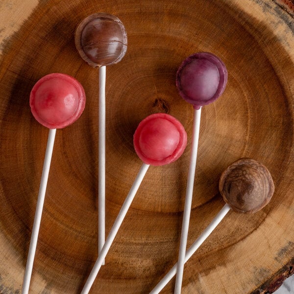 Four lollipops on cake pop sticks.