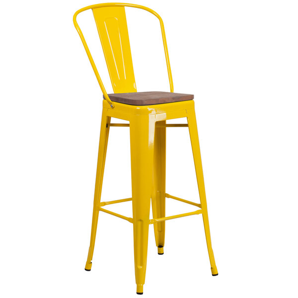a yellow bar stool with a wooden seat