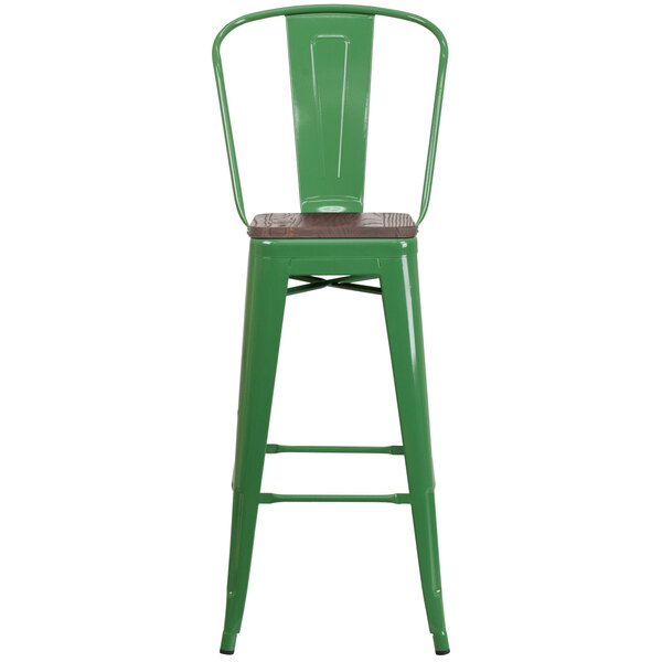 A green metal bar stool with a wood seat.
