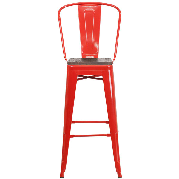 A red metal restaurant bar stool with a wooden seat and vertical slat back.