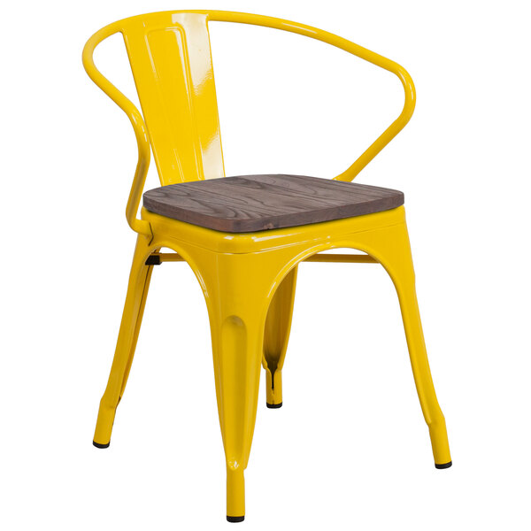A yellow Flash Furniture metal chair with a wooden seat and back on a outdoor patio.