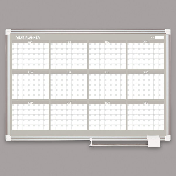 A white board with a calendar and white squares.