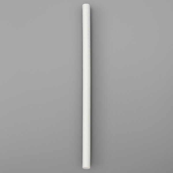 A white paper lollipop stick on a grey surface.