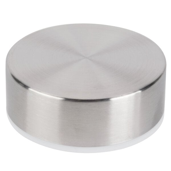 A silver circular Libbey Kinetix metal lid with a white surface.