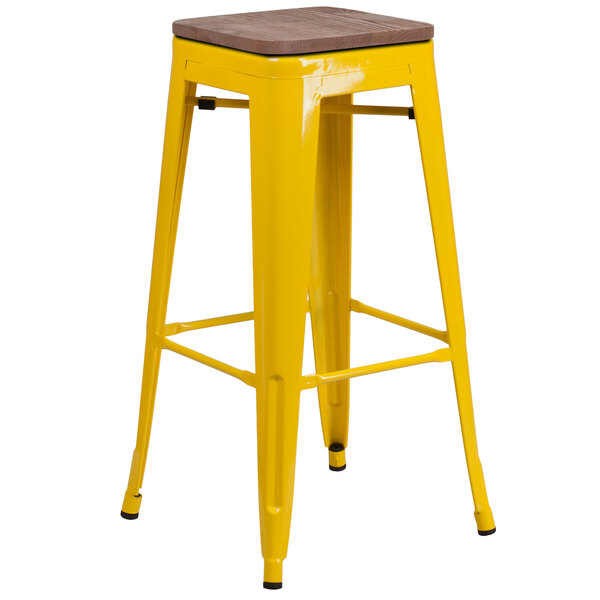 A yellow metal bar stool with a square wooden seat.