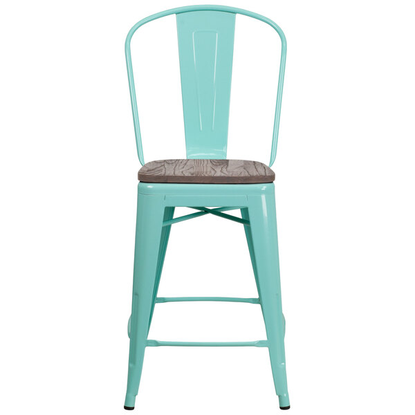 A mint green metal restaurant bar stool with a wood seat and vertical slat back.