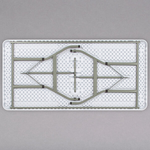 A Flash Furniture white plastic rectangular folding table with metal legs.
