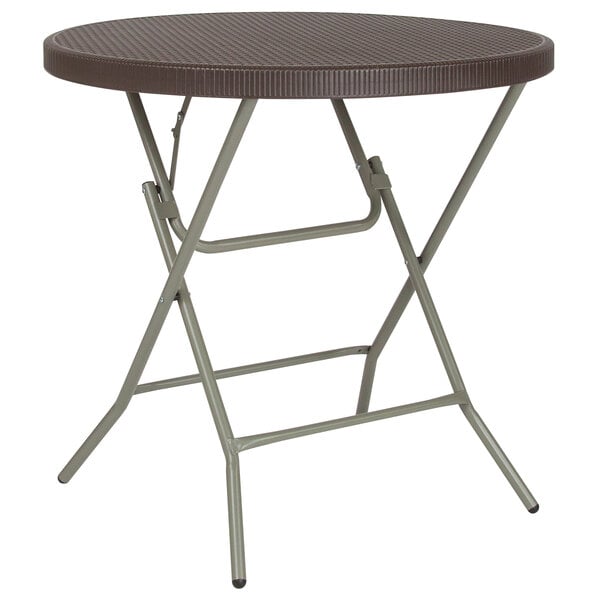 A Flash Furniture round brown rattan plastic folding table with a metal frame.