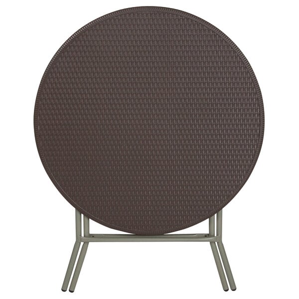A Flash Furniture round brown plastic folding table with a metal frame.