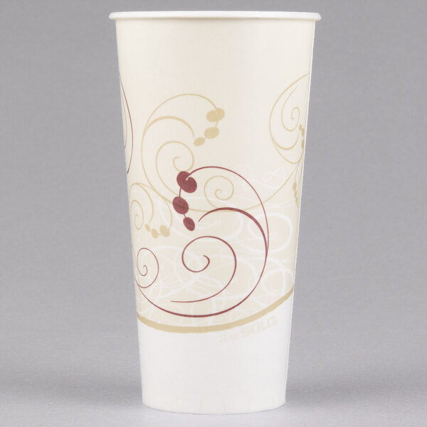 A white Solo paper cold cup with a gold swirl design.