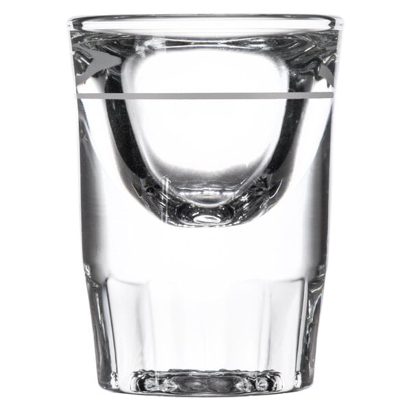A close up of a clear Libbey fluted shot glass with a white stripe at the bottom.