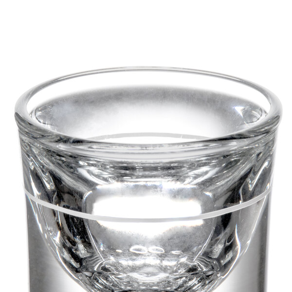 A clear Libbey fluted shot glass with a small hole in it.