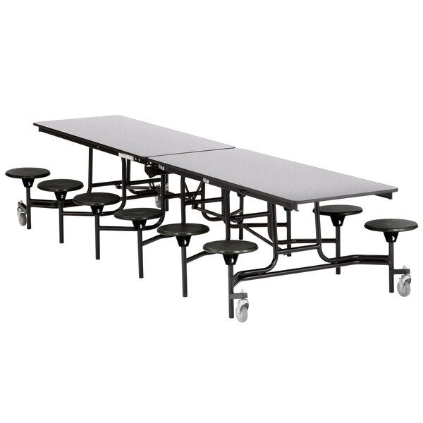 A rectangular plywood cafeteria table with metal legs and black stools.