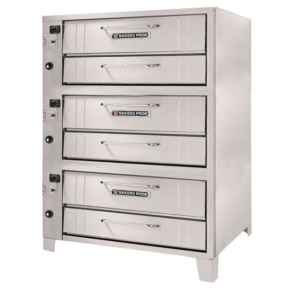 A Bakers Pride liquid propane pizza oven with three decks on a counter in a professional kitchen.