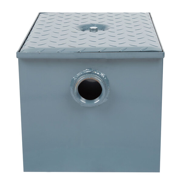 A grey metal square Watts grease trap with a threaded hole in the top.