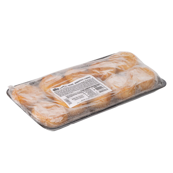 A plastic tray of Spring Glen Fresh Foods Fried Garlic Herb Risotto Cakes wrapped in plastic.
