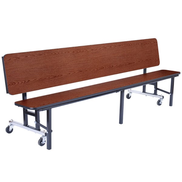 A National Public Seating wooden bench with wheels.