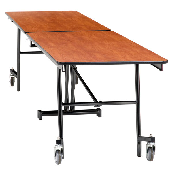 A National Public Seating rectangular cafeteria table with wheels.