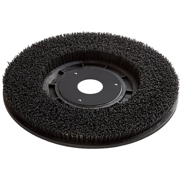 A green circular brush disc with a round center.