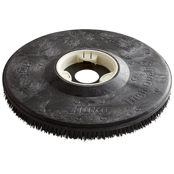 A black circular Minuteman Nylo-Grit brush disc with a white circle.