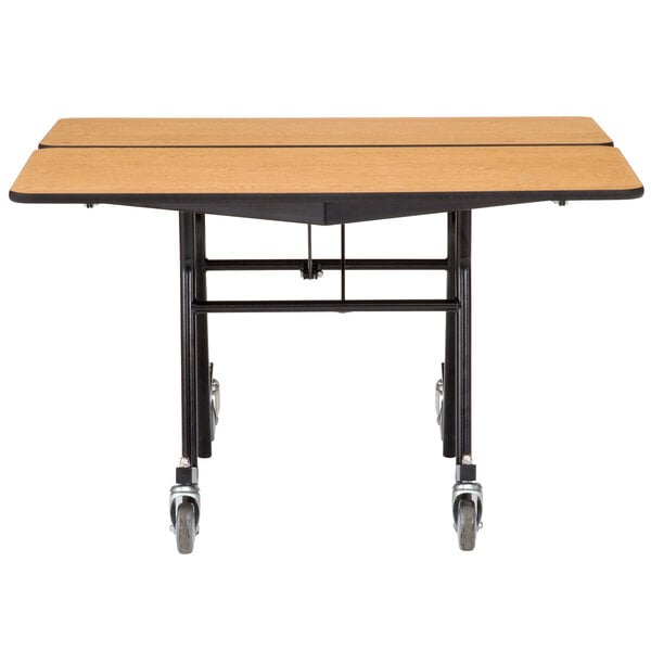 A National Public Seating 60" square mobile table with ProtectEdge and a chrome frame.