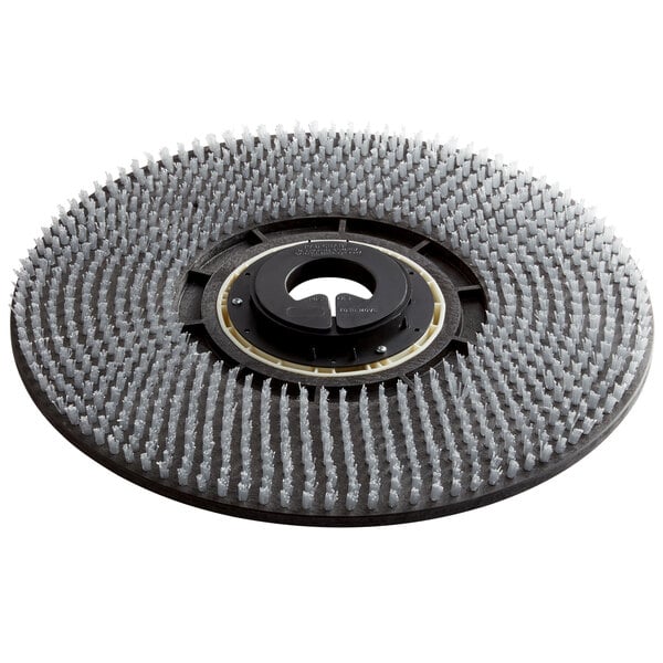 A black and white circular pad driver with bristles.