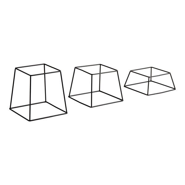 A set of three square black metal display stands in varying heights.