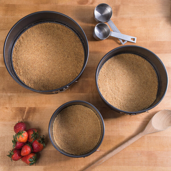 A Non-Stick Aluminized Steel Springform Cake Pan with brown food in it.