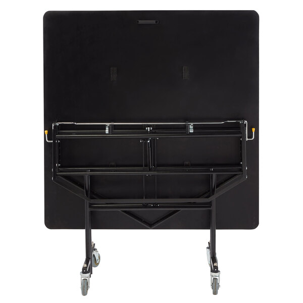 A black rectangular National Public Seating cafeteria table on wheels.