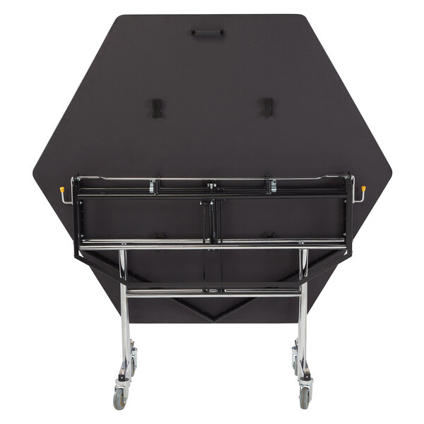 A black hexagon National Public Seating cafeteria table on wheels.