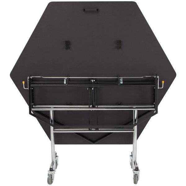 A black hexagon table on wheels.