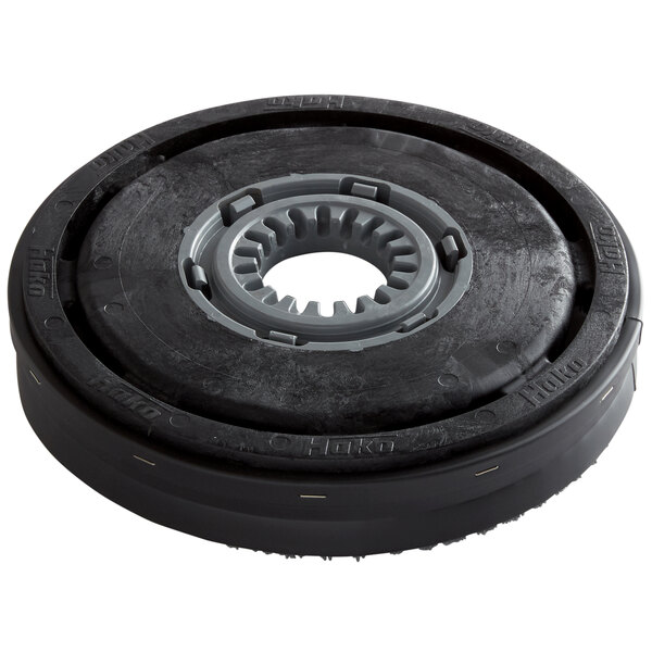 A black and grey circular Minuteman disc brush with a grey circle.