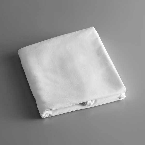A folded white Intedge rectangular tablecloth on a gray surface.