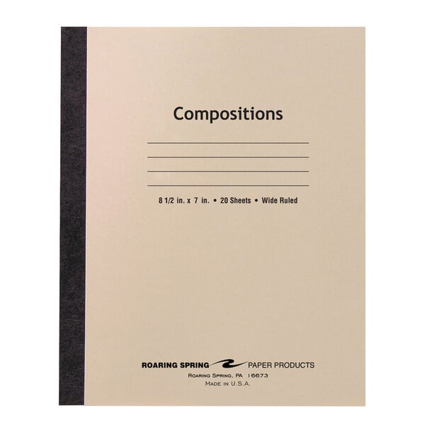 A close-up of a Roaring Spring composition book with wide ruled white paper and a manila cover with black text.